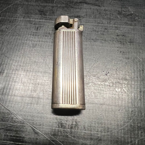 Silver lighter used, unknown if working