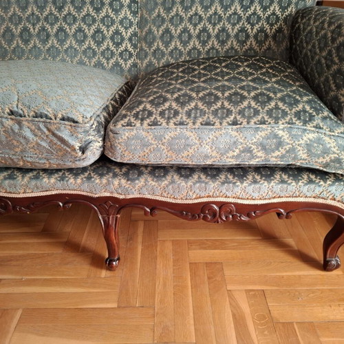 Vintage three-seater sofa and two antique armchairs with dark wood frame
