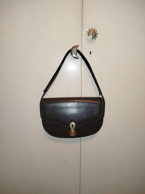 Black leather vintage handbag used with white residue