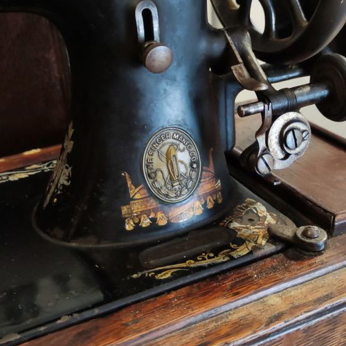 Singer sewing machine used with original wooden cover and key