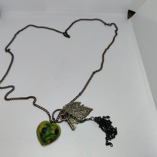 Vintage necklace with antique bronze elements and peacock feather heart pendant like new