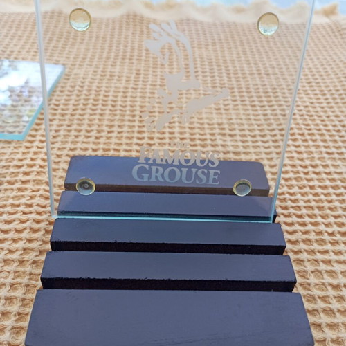 The Famous Grouse collectible glass coaster set with black ribbed base