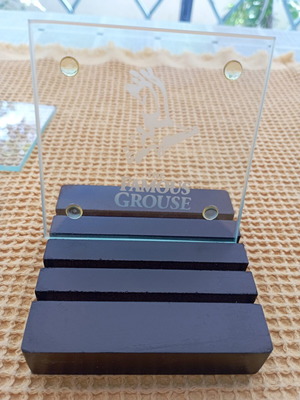 The Famous Grouse collectible glass coaster set with black ribbed base