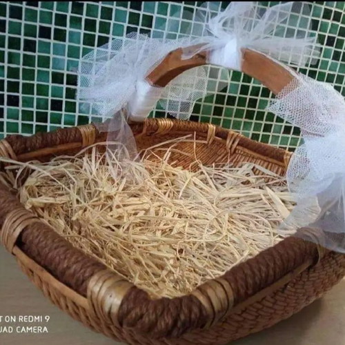 Wicker basket used with wooden handle and tulle decoration