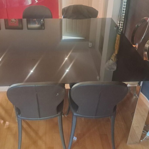 Room table with inox frame and black glass top, like new, with 4 chairs gift