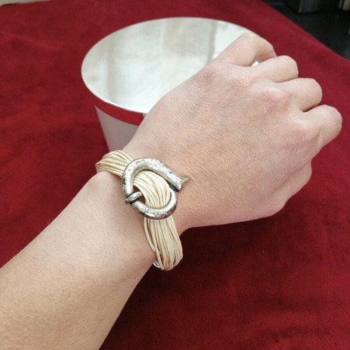 Bracelet with beige cords and metal elements like new