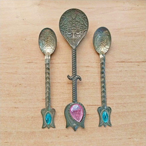 Decorative brass spoons with colored glass, set of three, used