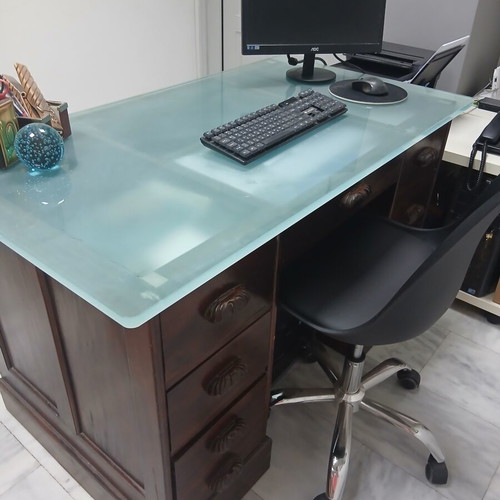 Desk made of walnut wood with green glass top and six drawers used