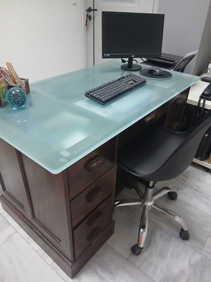 Desk made of walnut wood with green glass top and six drawers used