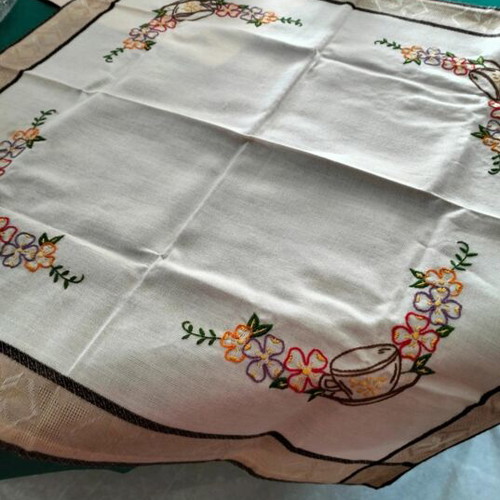 Embroidered square table linen with coffee cup and floral design