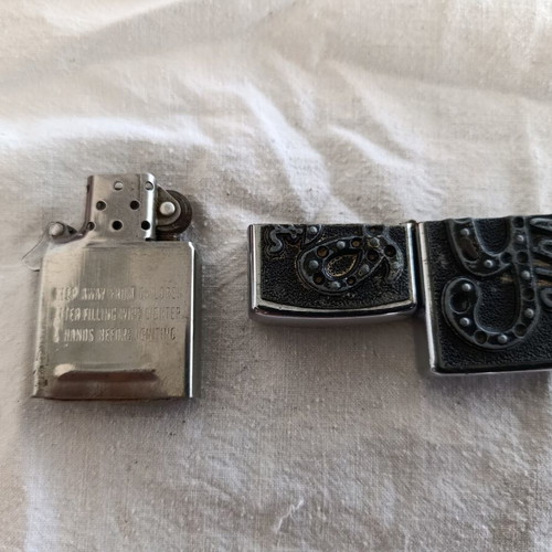 Windproof lighter with embossed metal emblem used