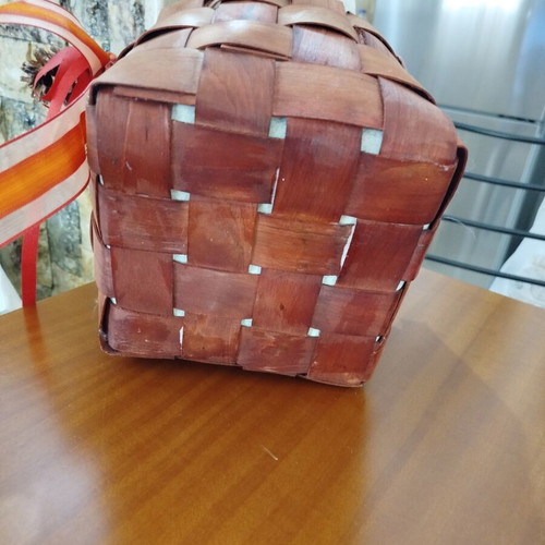 Wooden woven gift basket with leather handles, used