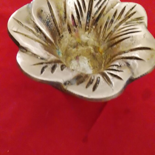 Carved brass decorative item, useful as ashtray or candle holder