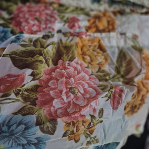 Vintage quilt with floral design, cream background
