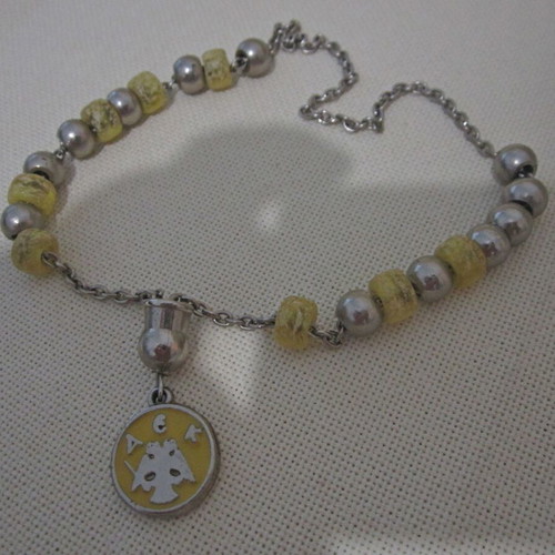 Vintage knotted AEK komboloi used with metal emblem