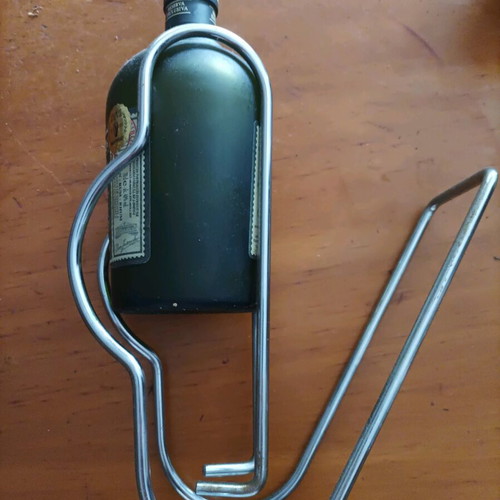 Bottle holder stainless like new with collectible rum bottle