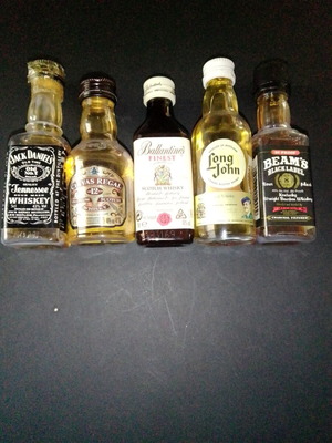 Miniature bottles of alcohol like new, sealed with half content