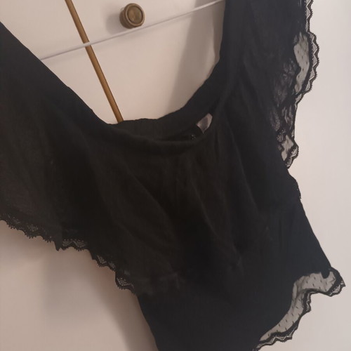 Black blouse with transparent polka dot design, off-shoulder