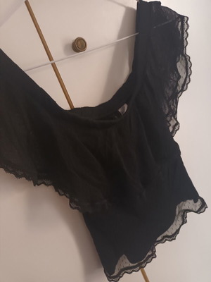 Black blouse with transparent polka dot design, off-shoulder