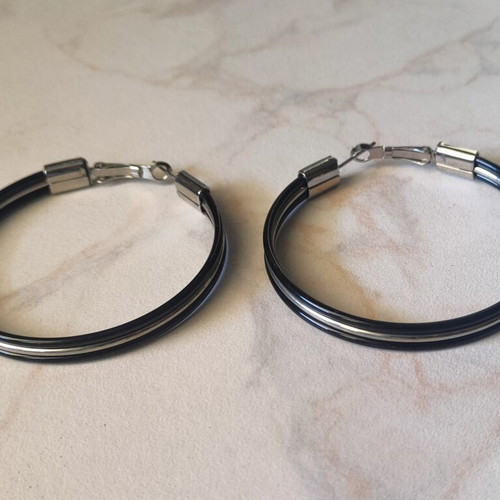Large black hoop earrings used with silver details