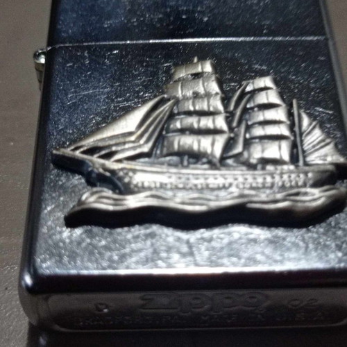 Zippo lighter with carved ship design