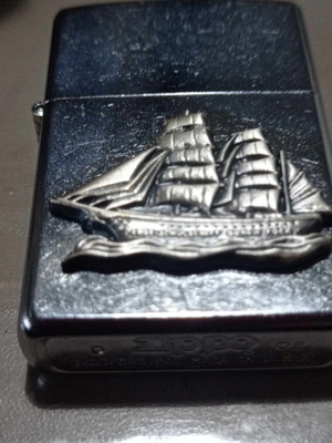 Zippo lighter with carved ship design