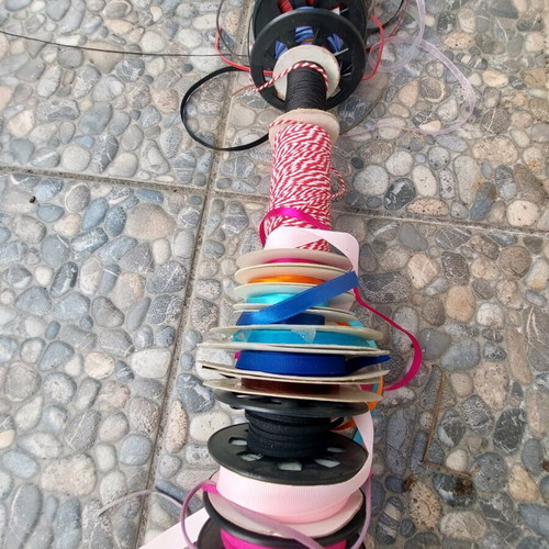 Wooden base with ribbons used for jewelry