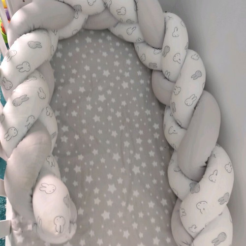 Baby braided crib bumper used in gray and white