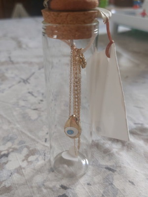Necklace with eye charm in glass jar new, gold color
