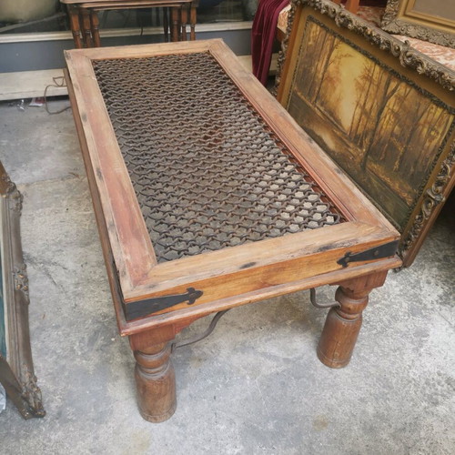 Vintage wooden coffee table used with industrial metal mesh design