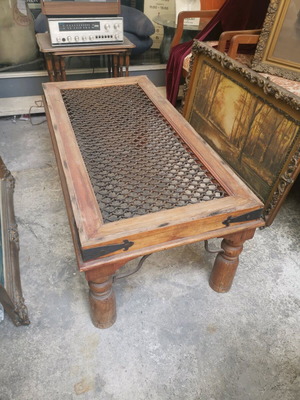 Vintage wooden coffee table used with industrial metal mesh design