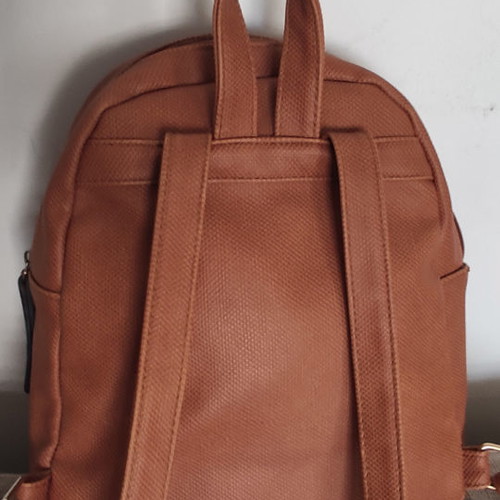 Back pack tan used with internal and external pockets
