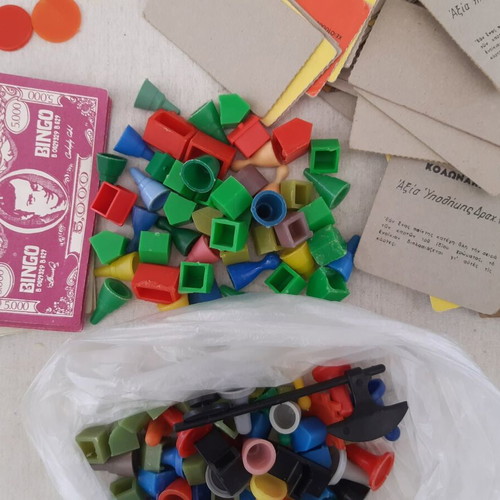 Lot of used game pieces, cards, and play money