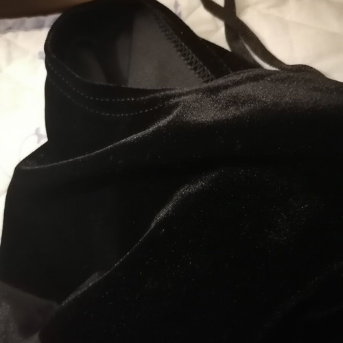 Black velvet jumpsuit with sheer mesh panel, halter neck