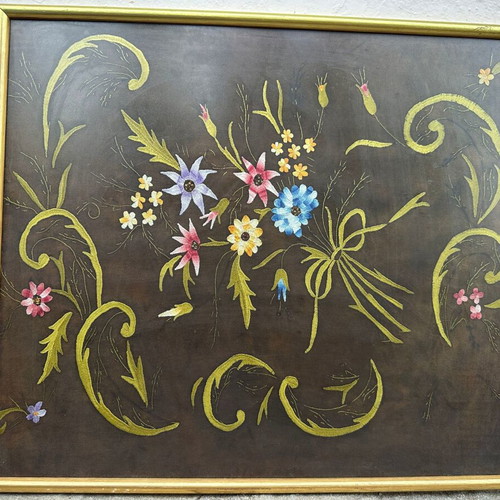 Vintage handmade embroidery textile art in frame
