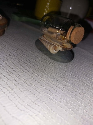 Handmade decorative piece with glass bottle and natural materials