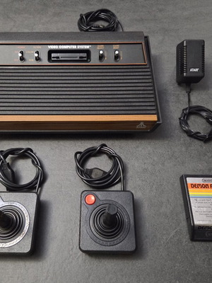 Atari 2600 VCS Woody console used with two joysticks and Demon Attack game