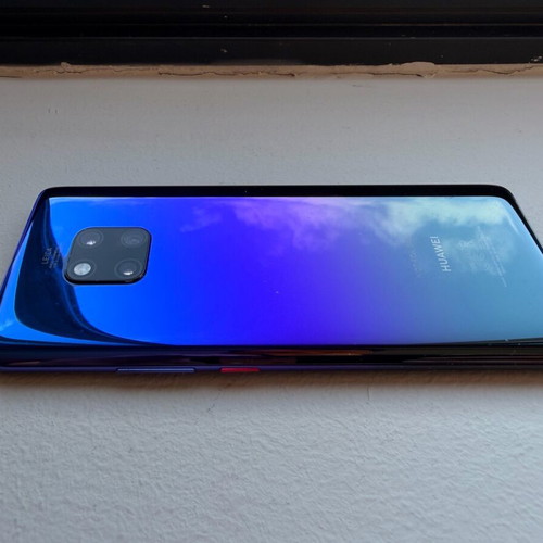 Huawei Mate 20 Pro smartphone with charging cable, cracked screen