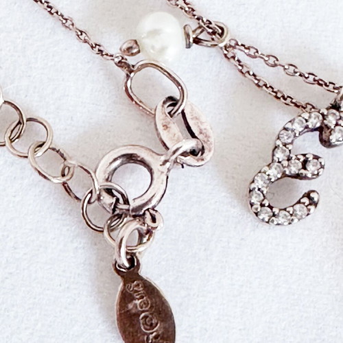 Gregio silver necklace used with rose quartz, pearls and zirconia charms