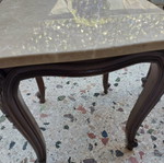Vintage side tables pair with natural marble used