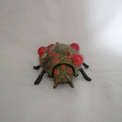Bronze ashtray used with red scarab-shaped stones