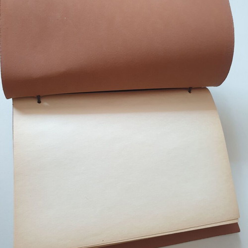 Handmade notebook with leather cover and metal airplane