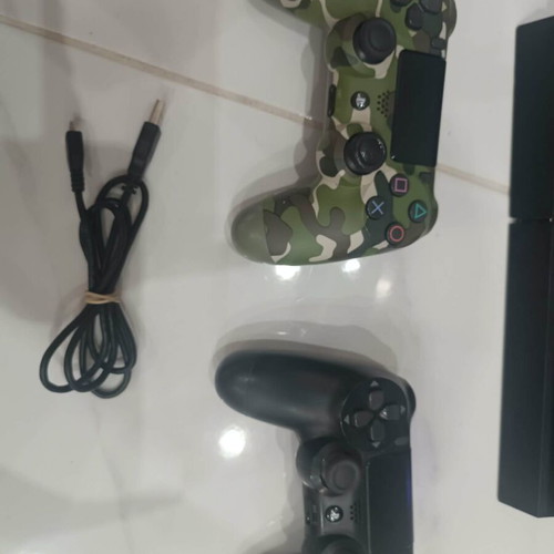 PlayStation 4 console with 2 controllers and cables