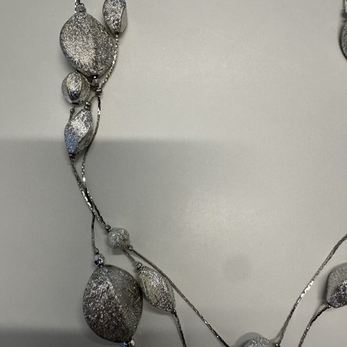 Triple necklace with silver pebble-like elements