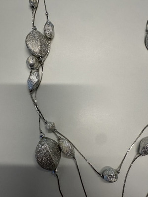 Triple necklace with silver pebble-like elements
