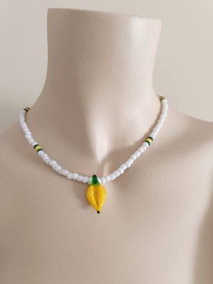 Handmade white short necklace with glass banana pendant