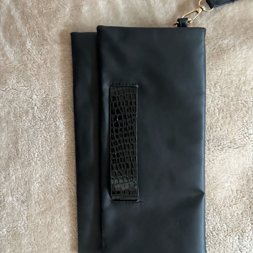 Handheld black clutch bag like new with leather detail