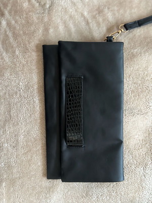 Handheld black clutch bag like new with leather detail