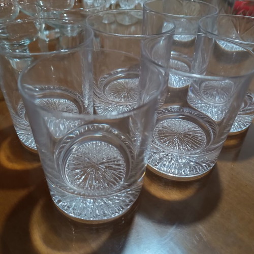 Set of 17 crystal glasses and bowls with carved details