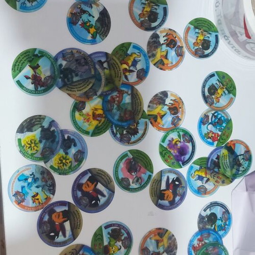 Various Pokémon and other collectible pogs